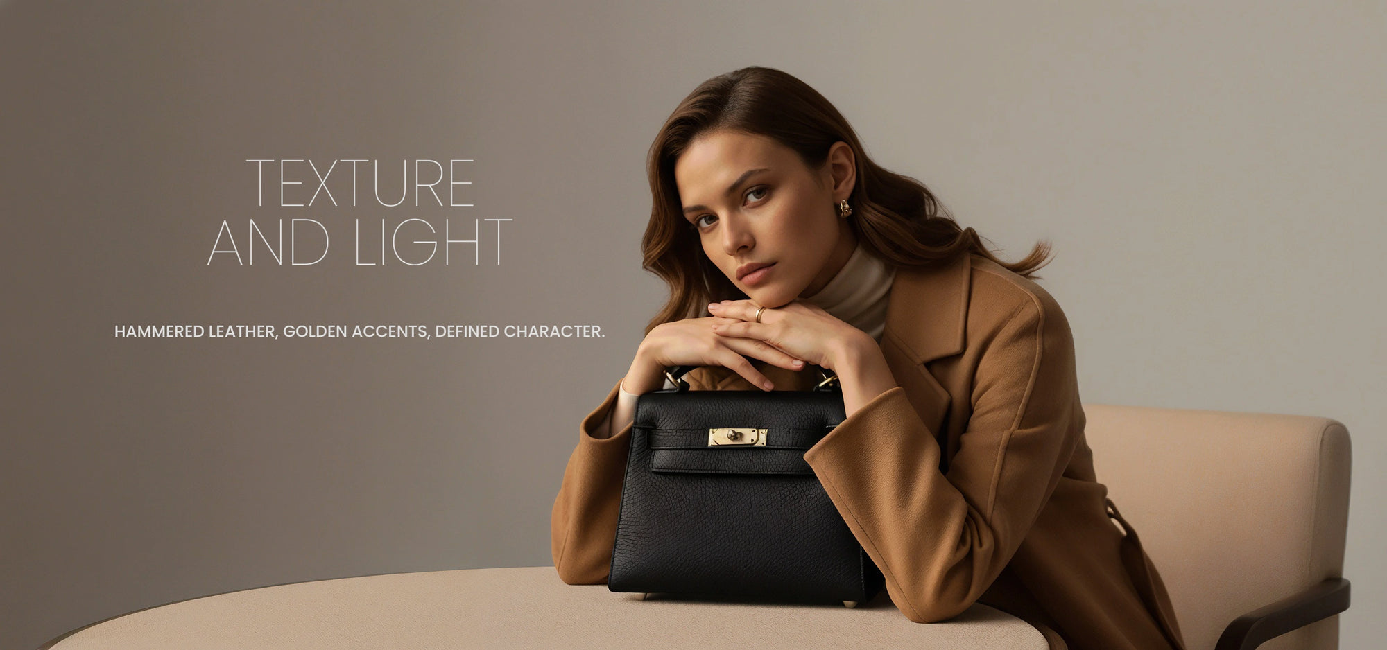 David Halfon Fall Winter 2025 campaign featuring black handbag with gold hardware — elegant woman in camel coat