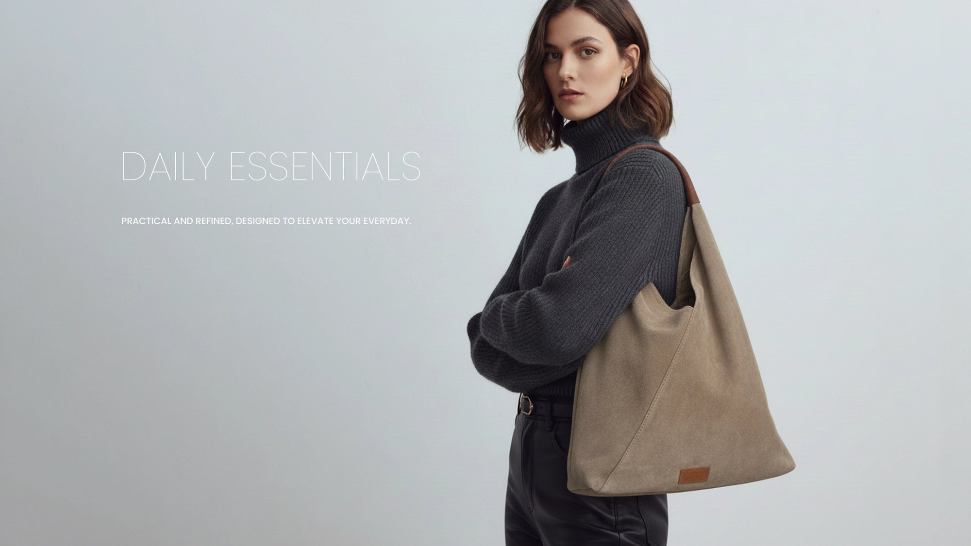 David Halfon DH Murad suede shoulder shopper bag in taupe, worn by model in grey turtleneck.