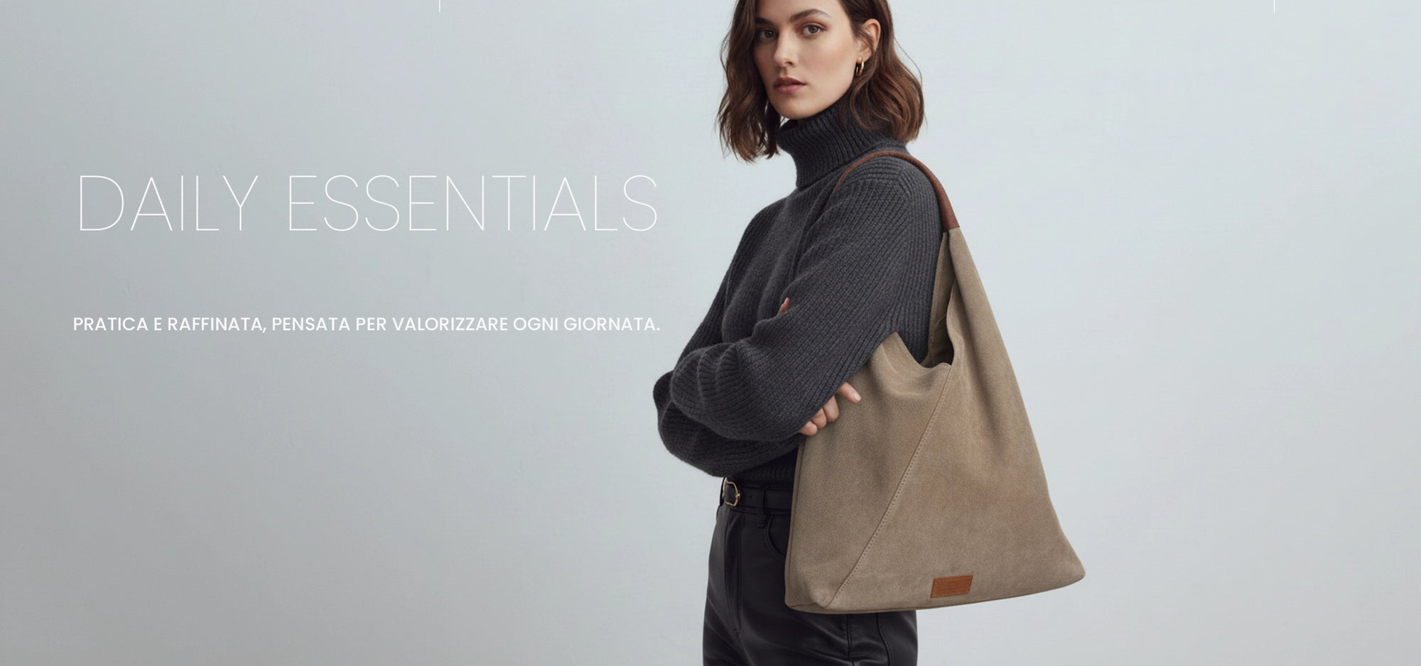 David Halfon DH Murad suede shoulder shopper bag in taupe, worn by model in grey turtleneck.
