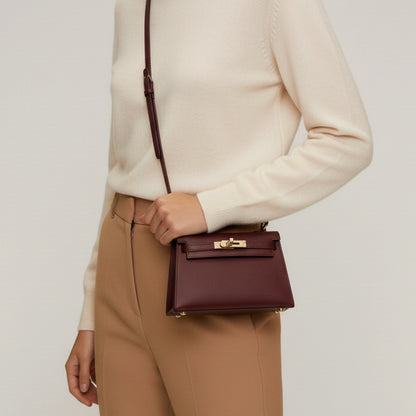 Diana S top-handle bag in hammered leather burgundy red — shoulder-worn view on model